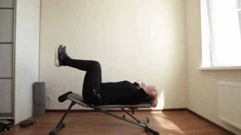 Man exercising in home gym, using fitness equipment for body training, stri.. Stock Footage 284543710