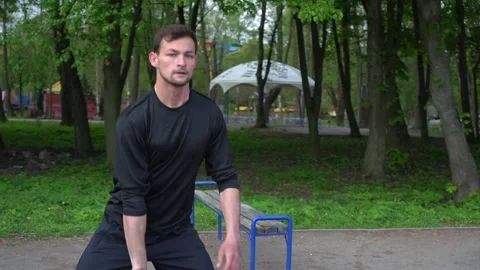 Man exercising with kettlebell in the park Stock Footage 130817670