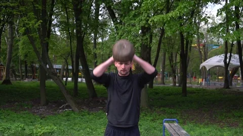 Man exercising with kettlebell in the park. Slow motion Stock Footage 130817963