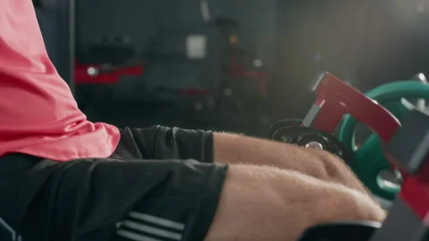 Man Exercising on Leg Extension Machine in Fitness Gym Stock Footage 345203351