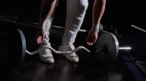 A man is exercising by lifting barbells. Stock Footage 5164376