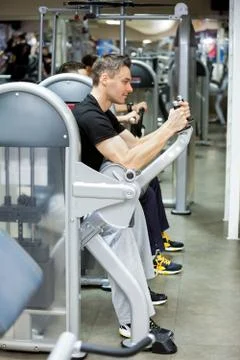 Man exercising on machines Stock Photos