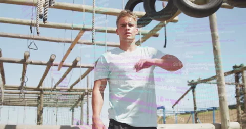 Man exercising on outdoor obstacle course with digital code overlay animation Vidéo 303676330