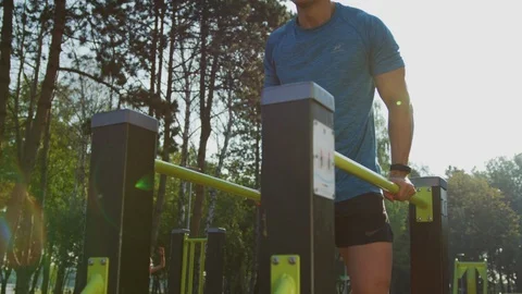 Man exercising on parallel bars Stock Footage 100031318