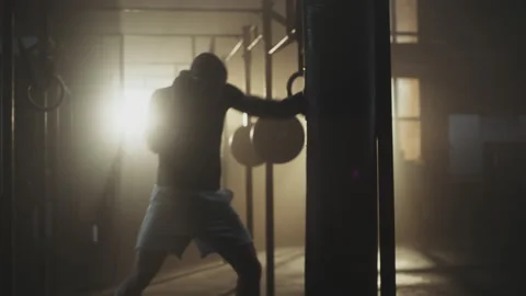 Man exercising with punching bag Stock Footage 236192623