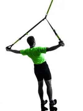 Man exercising suspension training  trx silhouette Fotos de archivo