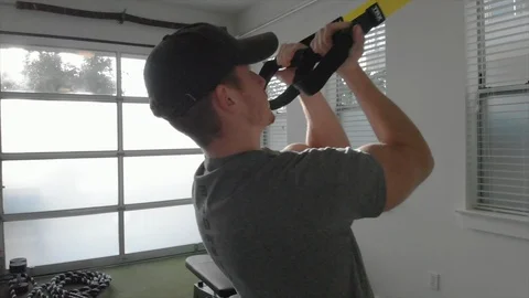 Man exercising with TR-X cables as camera pulls back Stock Footage 90828618