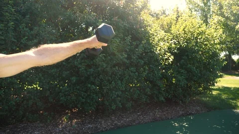 Man exercising, training, working out outdoors, shoulder raises, 4k, 60fps. Stock Footage 116337284