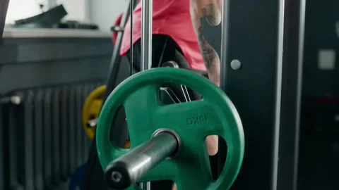 Man Exercising on Weight Machine for Strength Training in Gym Stock Footage 345202202