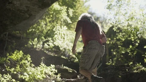 Man exiting the cave Stockbeeldmateriaal 91961059