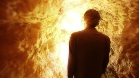 Man exits from dark cave to light in exterior, slow motion Stock Footage 119140830