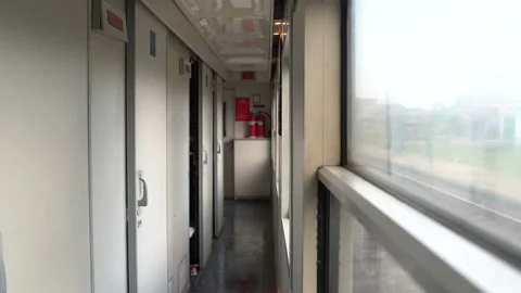 A man exits the train compartment and goes to the vestibule Stock Footage 91430944