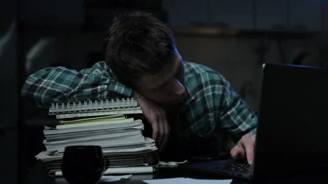 A man experiences difficulties due to fatigue while working late at night. A you Stock Footage 296884295