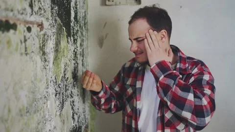A man experiences a headache from exposure to black toxic mold Video stock 238681016