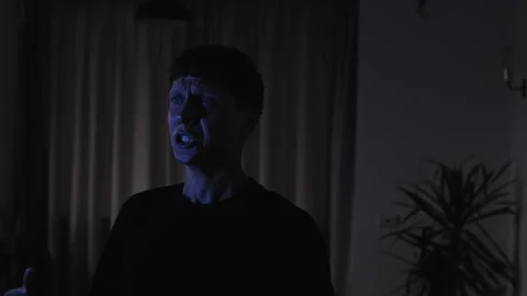 Man experiencing an intense emotional breakdown, shouting with clenched fists Видео 347300678