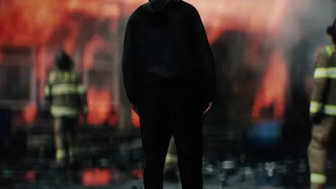Man Experiencing Loss of Home Standing in Front of Burning Home 스톡 동영상 336516144