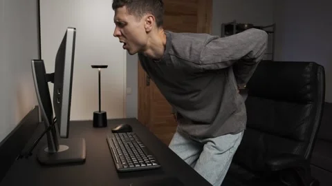 Man experiencing lower back pain office syndrome sedentary lifestyle health risk Stock Footage 315414240
