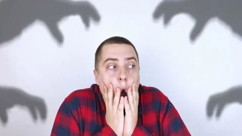 The man is experiencing a panic attack. The concept of phobia, fears, paranoia a Stock Footage 154636823