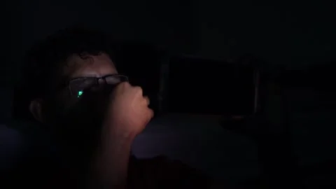 Man experiencing sleep deprivation using smartphone at night Stock Footage 301087976