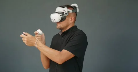 Man experiencing virtual or mixed reality in modern VR goggles. Stock Footage 257604449