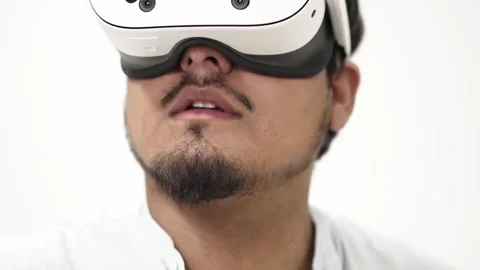 Man experiencing virtual reality headset on white background 스톡 동영상 309772196