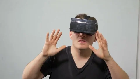 Man experiencing virtual reality with wearing special headset Stock Footage 71472994