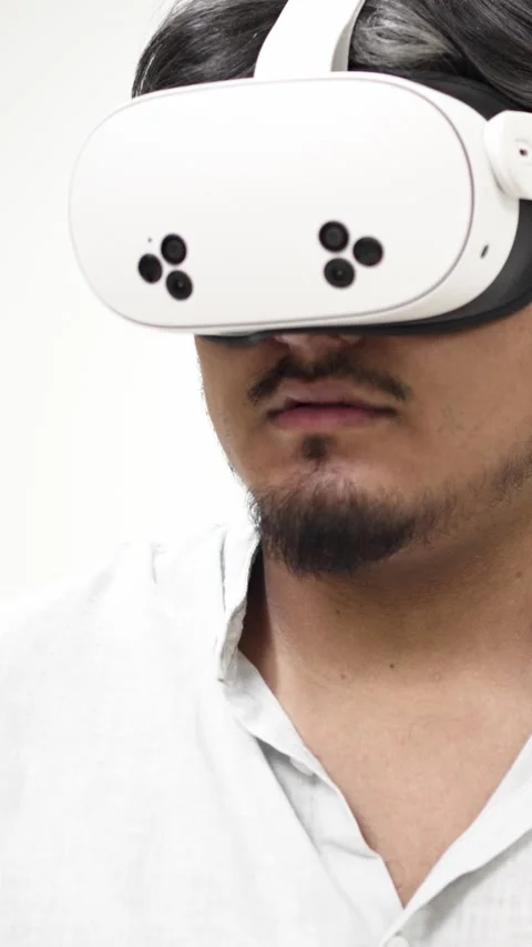 Man experiencing virtual reality with white VR headset Stock Footage 309773084