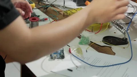 A man experimenting with a PCB in an Electrical Engineering Laboratory  Stock Footage 307622005