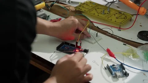 A man experimenting with a PCB in an Electrical Engineering Laboratory  Stock Footage 307622324