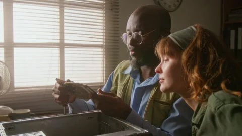 Man Explaining Computer Hardware to Woman Stock Footage 341427196