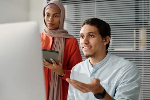Man explaining data on computer screen 스톡 사진