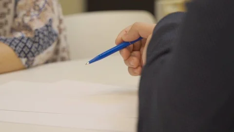 Man explaining with a pen in hands Stock Footage 129691564