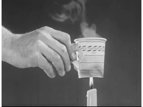 A man explains how heat is released through a radiator in a car's engine in the Video stock 75082594