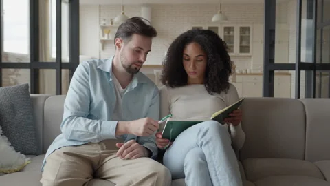 Man Explains Idea While Woman Takes Notes During Home Brainstorm Session Video stock 306697826