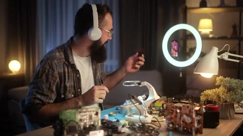 A man explains the process of creating an FPV drone. The young engineer is Stock Footage 261145630