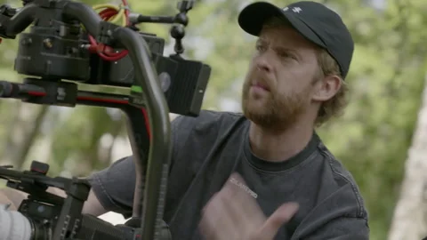 Man explains settings adjusting gear during film shooting Vídeo Stock 308932638