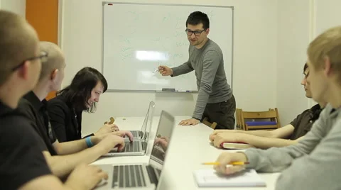 The Man Explains The Task Small Group. Paints And Shows On The Board Video stock 52718296