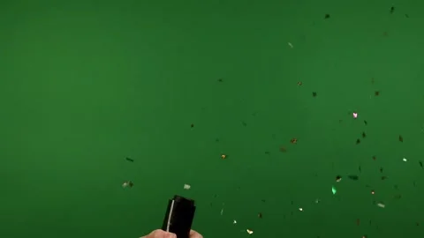 Man explodes a firecracker with shiny confetti footageschromakey, green screen Stock Footage 312591624