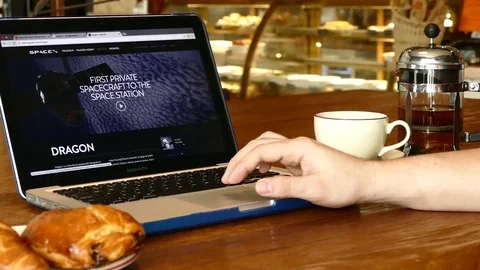 Man explore Space X website on laptop screen in cafe Stock Footage 75183486