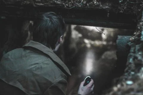 Man explores the basement with a flashlight Stock Photos