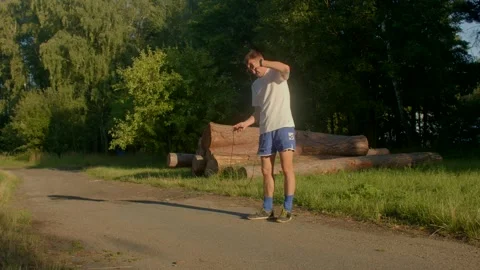 A man explores the wilderness, checks his phone, ties his shoes Stock-Footage 314346855