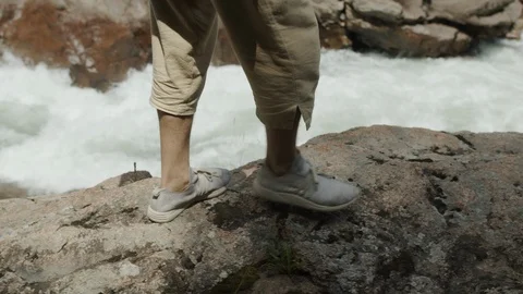 Man exploring the banks of the river in the granite canyon Stock Footage 112734009