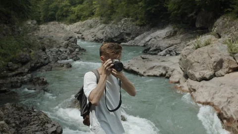 Man exploring the banks of the river in the granite canyon Stock Footage 112734096