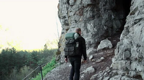 Man exploring a cave Stock Footage 63096640