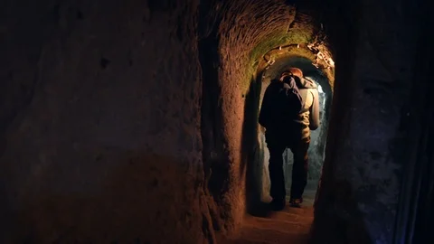Man exploring caves in Kaymakli underground city Stock Footage 90724112