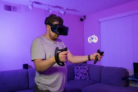 Man exploring digital world through virtual reality headset Stock Photos