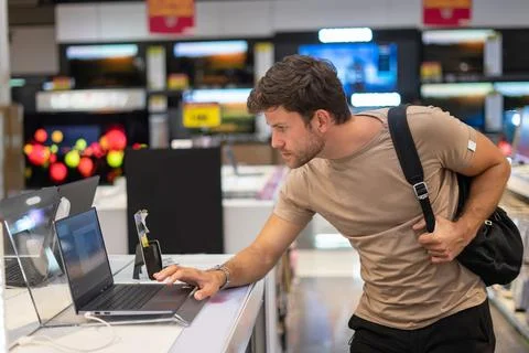 Man exploring new gadget in e store Stock Photos