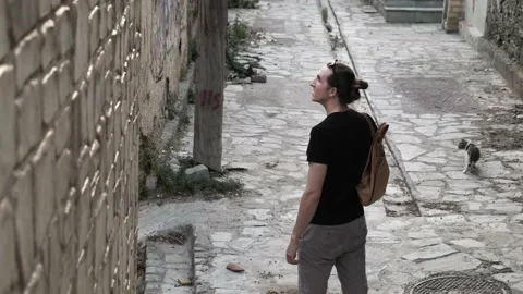 Man exploring old city streets Stock Footage 200009422
