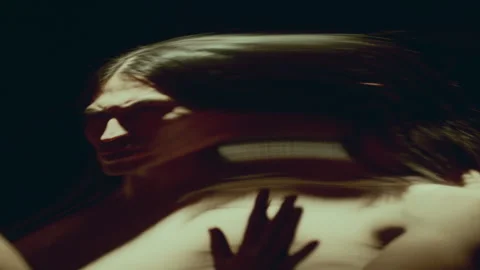 Man Exploring Surreal, Contorted Reflection of Himself in Distorting Mirror Stock Footage 289880684