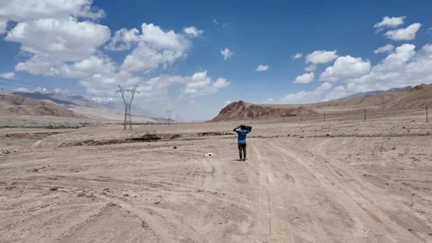 Man Exploring Vast Gobi Desert Landscape in Xinjiang, China Stock Footage 339629711